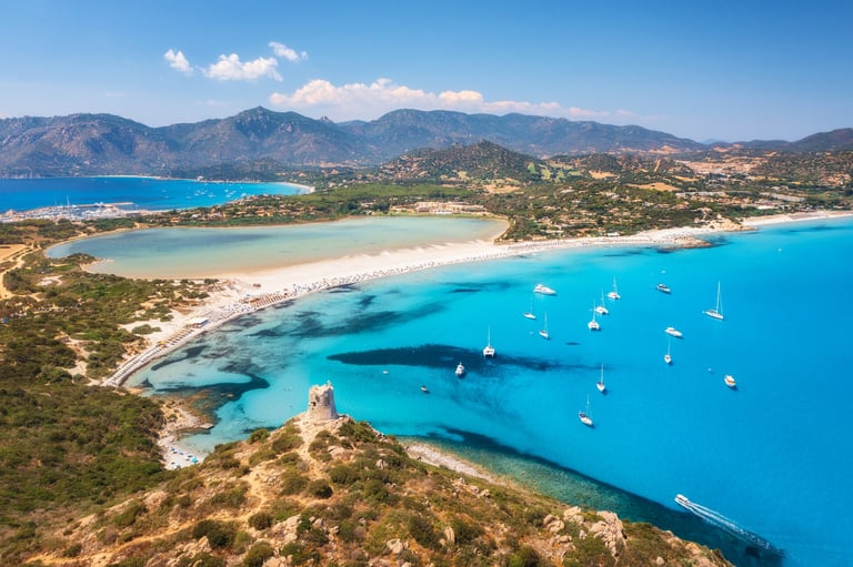 Sardinia Italy - Aerial view of Porto Giunco beach with clear blue water and white sand